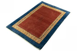 Corner detail of 2000s Persian Gabbeh rug showing border pattern and Wool pile