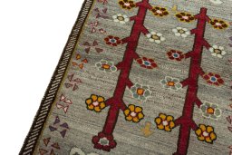 Backside of handmade 2000s Persian Gabbeh rug showing knot structure and weave density