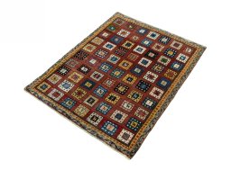Corner detail of 2000s Persian Gabbeh rug showing border pattern and Wool pile