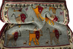 Corner detail of 2000s Persian Gabbeh rug showing border pattern and Wool pile