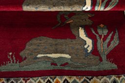 Full view of 2000s Persian Gabbeh rug from Iran / Persia, 128 × 100 cm in Red tones