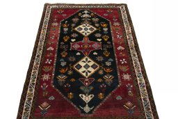 Surface texture of 2000s Persian Gabbeh rug with natural Wool and intricate pattern