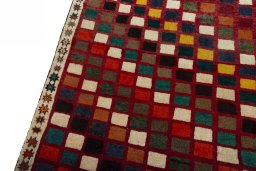 Backside of handmade 2000s Persian Gabbeh rug showing knot structure and weave density