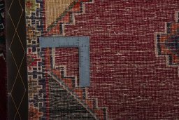 Corner detail of 2000s Persian Gabbeh rug showing border pattern and Wool pile