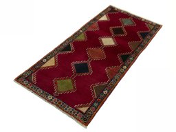 Corner detail of 2000s Persian Gabbeh rug showing border pattern and Wool pile
