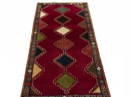 Surface texture of 2000s Persian Gabbeh rug with natural Wool and intricate pattern
