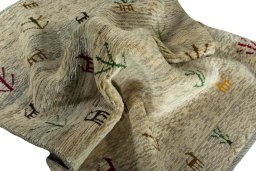 Corner detail of 2000s Persian Gabbeh rug showing border pattern and Wool pile