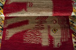 Full view of 2000s Persian Gabbeh rug from Iran / Persia, 131 × 82 cm in Red tones