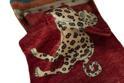 Corner detail of 2000s Persian Gabbeh rug showing border pattern and Wool pile