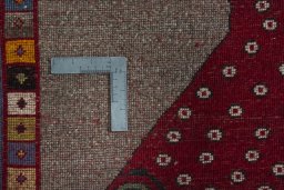 Corner detail of 2000s Persian Gabbeh rug showing border pattern and Wool pile