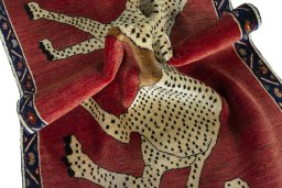 Corner detail of 2000s Persian Gabbeh rug showing border pattern and Wool pile