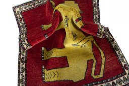 Corner detail of 2000s Persian Gabbeh rug showing border pattern and Wool pile