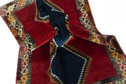 Corner detail of 2000s Persian Gabbeh rug showing border pattern and Wool pile