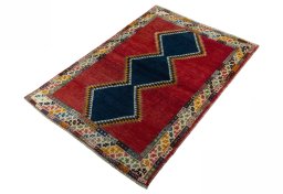 Corner detail of 2000s Persian Gabbeh rug showing border pattern and Wool pile