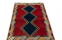 Surface texture of 2000s Persian Gabbeh rug with natural Wool and intricate pattern