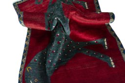 Corner detail of 2000s Persian Gabbeh rug showing border pattern and Wool pile