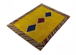 Corner detail of 2000s Persian Gabbeh rug showing border pattern and Wool pile