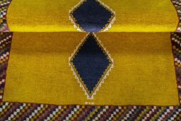 Full view of 2000s Persian Gabbeh rug from Iran / Persia, 140 × 106 cm in Yellow tones