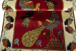Full view of 2000s Persian Gabbeh rug from Iran / Persia, 158 × 92 cm in Red tones