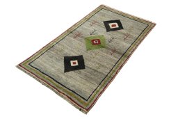 Corner detail of 2000s Persian Gabbeh rug showing border pattern and Wool pile
