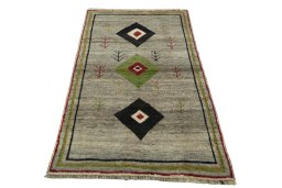 Surface texture of 2000s Persian Gabbeh rug with natural Wool and intricate pattern