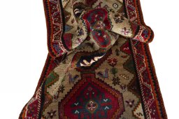 Corner detail of 2000s Persian Gabbeh rug showing border pattern and Wool pile