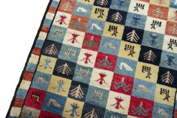 Backside of handmade 2000s Persian Gabbeh rug showing knot structure and weave density