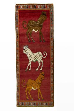 Full view of 2000s Persian Gabbeh rug from Iran / Persia, 281 × 104 cm in Red tones