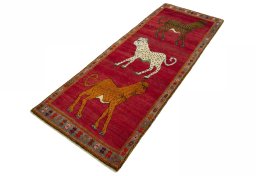 Corner detail of 2000s Persian Gabbeh rug showing border pattern and Wool pile