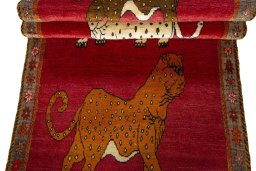 Full view of 2000s Persian Gabbeh rug from Iran / Persia, 281 × 104 cm in Red tones