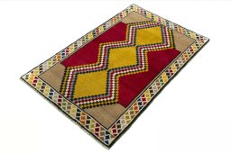 Corner detail of 2000s Persian Gabbeh rug showing border pattern and Wool pile
