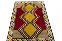 Surface texture of 2000s Persian Gabbeh rug with natural Wool and intricate pattern