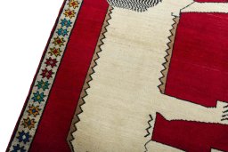 Backside of handmade 2000s Persian Gabbeh rug showing knot structure and weave density