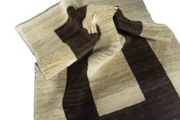 Corner detail of 2000s Persian Gabbeh rug showing border pattern and Wool pile