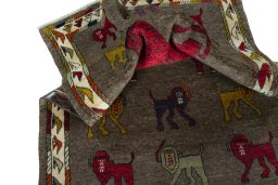 Corner detail of 2000s Persian Gabbeh rug showing border pattern and Wool pile