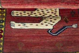 Full view of 2000s Persian Gabbeh rug from Iran / Persia, 135 × 100 cm in Red tones