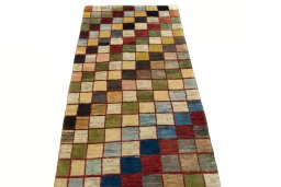 Surface texture of 2000s Persian Gabbeh rug with natural Wool and intricate pattern