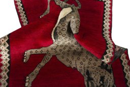 Corner detail of 2000s Persian Gabbeh rug showing border pattern and Wool pile