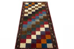 Surface texture of 2000s Persian Gabbeh rug with natural Wool and intricate pattern