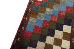 Backside of handmade 2000s Persian Gabbeh rug showing knot structure and weave density