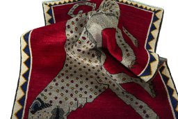 Corner detail of 2000s Persian Gabbeh rug showing border pattern and Wool pile