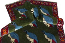Corner detail of 2000s Persian Gabbeh rug showing border pattern and Wool pile