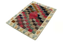 Corner detail of 2000s Persian Gabbeh rug showing border pattern and Wool pile