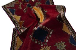 Corner detail of 2000s Persian Gabbeh rug showing border pattern and Wool pile
