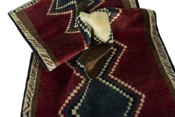 Corner detail of 2000s Persian Gabbeh rug showing border pattern and Wool pile