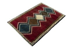 Corner detail of 2000s Persian Gabbeh rug showing border pattern and Wool pile