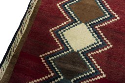 Backside of handmade 2000s Persian Gabbeh rug showing knot structure and weave density