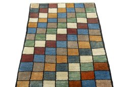 Surface texture of 2000s Persian Gabbeh rug with natural Wool and intricate pattern