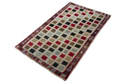 Corner detail of 2000s Persian Gabbeh rug showing border pattern and Wool pile