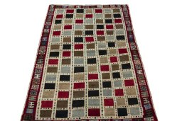 Surface texture of 2000s Persian Gabbeh rug with natural Wool and intricate pattern
